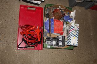 A box containing various tools including jump lead