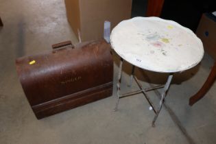 A circular painted metal occasional table on wroug