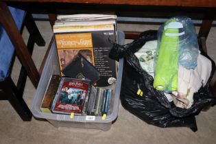 A box of CD's and a bag of various curtains