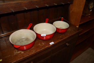 Three graduated Le Creuset saucepans