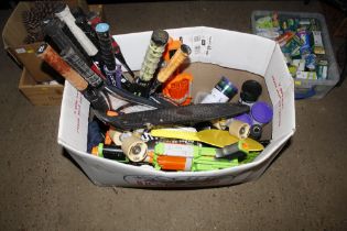 A box containing Nerf guns, various sporting racke