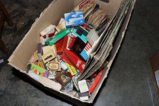A box of various vintage matchboxes, cigarette pac