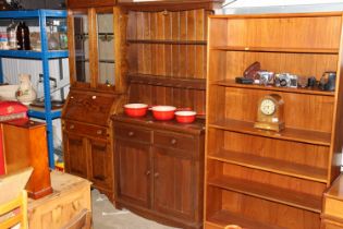 A small oak dresser with shelved and boarded back