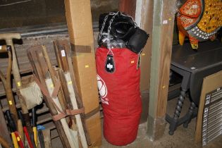 A boxing bag, gloves and pads