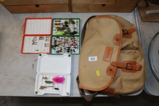 A Barbour fishing bag and various fishing flies