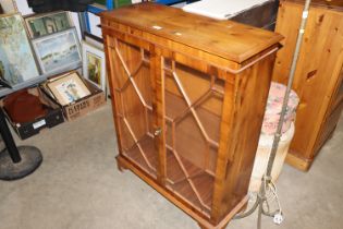 A reproduction yew wood bookcase