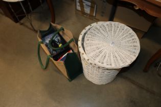 A wickerwork laundry basket and a bag of CDs, DVDs