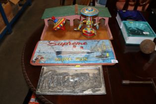 A vintage paint box, two tin plate toys, a child's