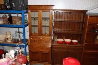 An early 20th Century oak bureau bookcase with lea