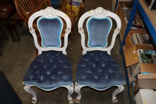 Two white and gilt painted chairs with button seat