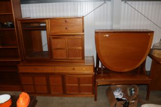 A teak drop leaf dining table; and a similar oblon