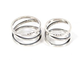 Two modern design silver napkin rings, both with s