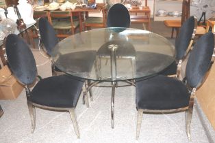 A circular plate glass and chrome based dining tab