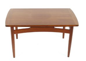 A 1970's teak oblong coffee table, raised on round