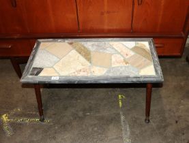 A decorative coloured marble topped coffee table,