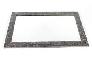 A large decorative silvered framed bevel edged wal