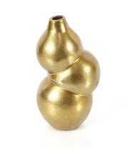 A gold coloured baluster vase of bubble shape, 24c