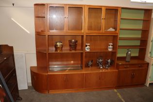 A teak G-plan wall unit, fitted glazed cabinets, o