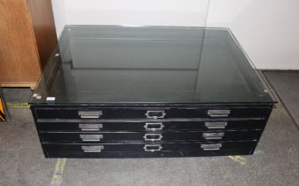 A black wood four drawer low plans chest, fitted m