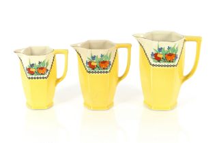 A set of three Art Deco design yellow ground jugs,