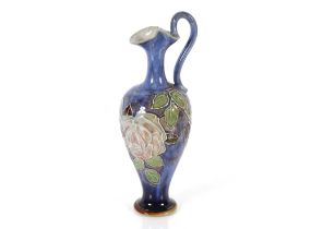 A Doulton pottery baluster ewer, decorated flowers
