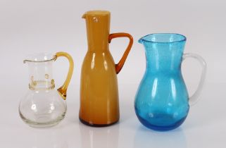 A blue tinted baluster water jug; an amber tinted