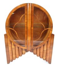 An Art Deco "Rocket" walnut display cabinet, the circular cabinet enclosed by glazed doors (