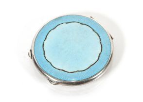 A circular silver compact with two tone enamel dec