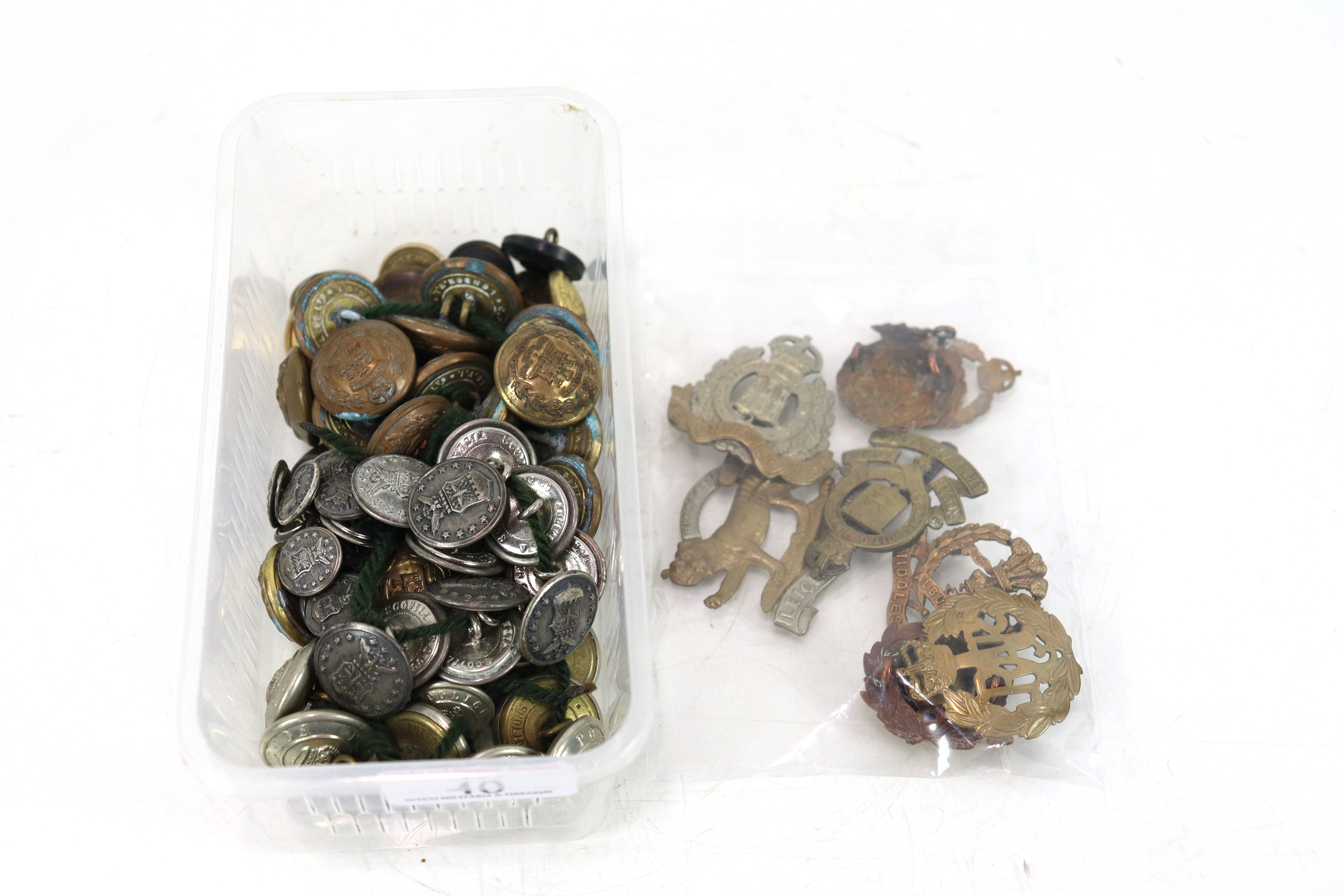 A quantity of various buttons and cap badges etc.