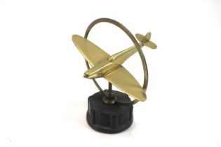 A cast brass Spitfire model mounted on Bakelite ba