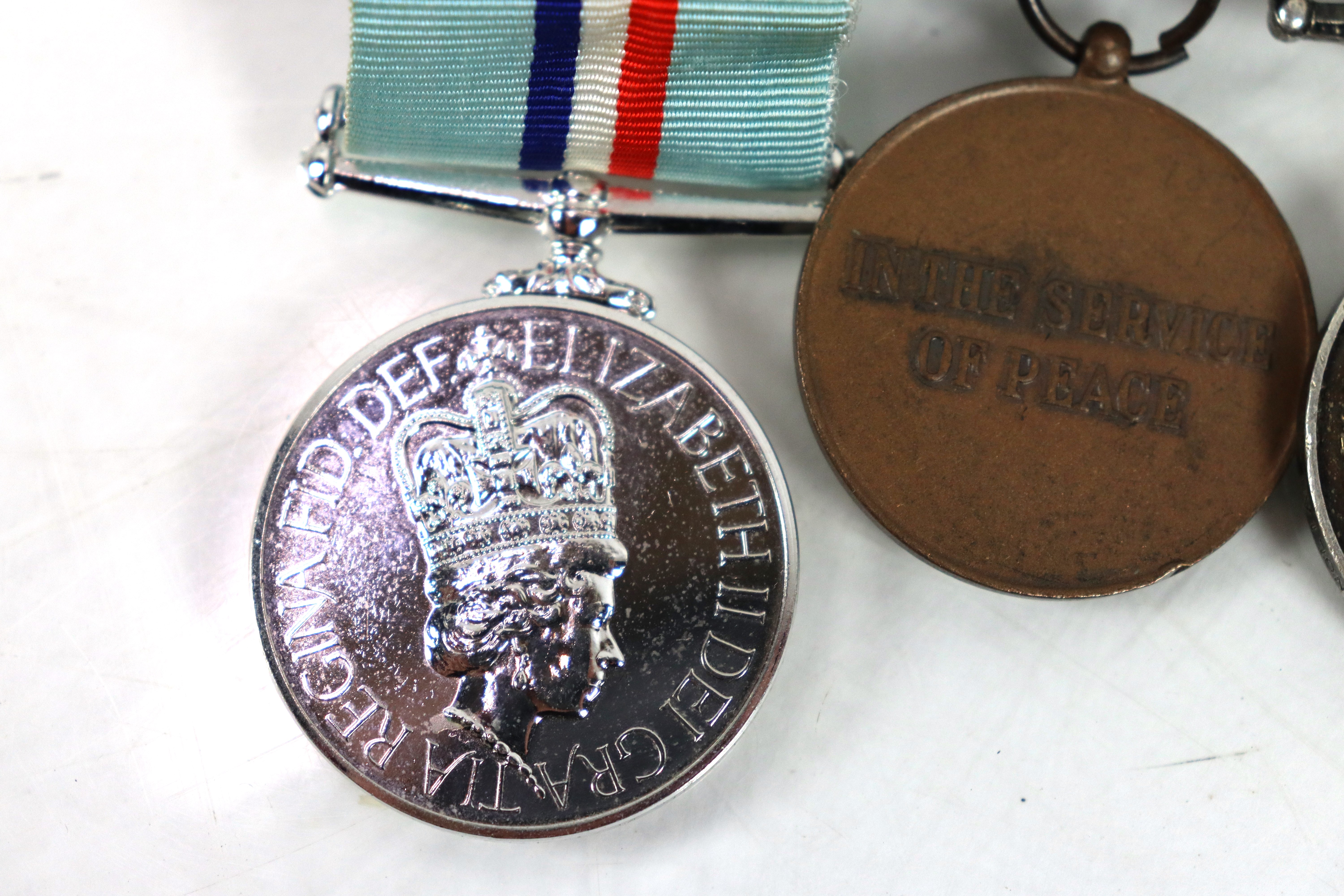 A Royal Anglian Regiment group of three medals, E. - Image 5 of 7