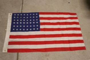 A U.S.A. flag marked U.S.N. and 1941