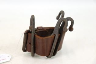 A WWI era leather mounted tentpole clothes hooks