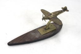 A good model brass spitfire mounted on wooden "Tea