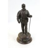 A bronzed resin figure of a soldier with his S.L.R.