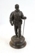 A bronzed resin figure of a soldier with his S.L.R.