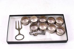 Nine silver plate napkin rings, all with broad arr