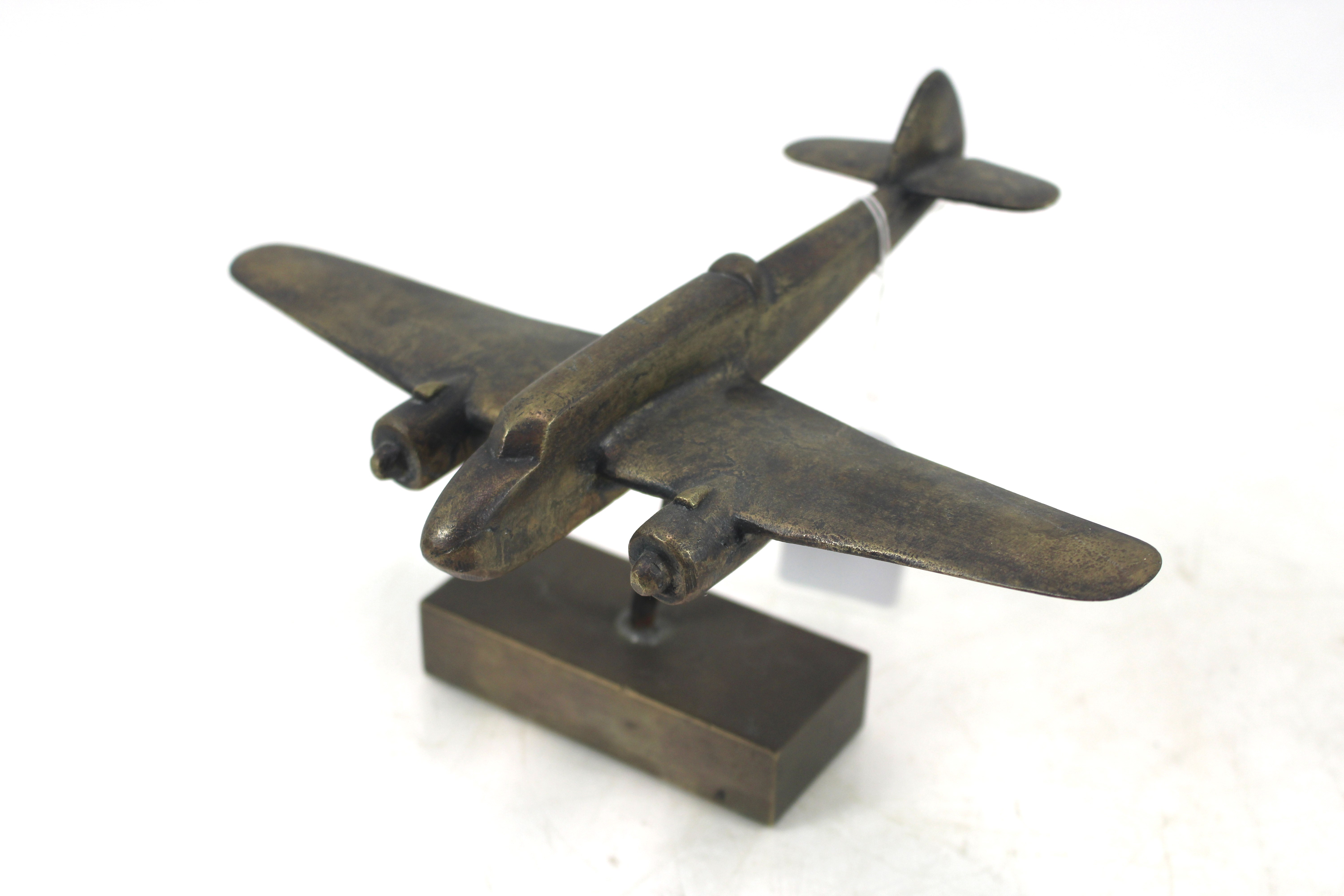 A cast brass Beau fighter model on brass block bas