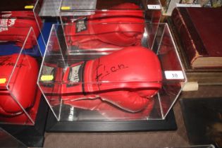 A cased boxing glove with signature