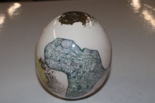 An ostrich egg with transfer printed decoration