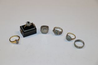 A box containing silver and dress rings