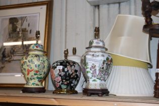 Three Oriental table lamps and a white glazed tabl