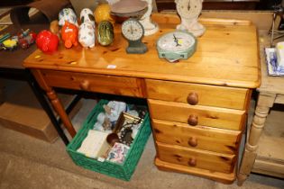 A pine dressing table fitted five drawers