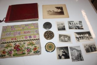 A box containing compacts, a sampler, photo album