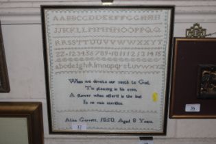 A framed sampler by Alice Garrett 1850, aged 8