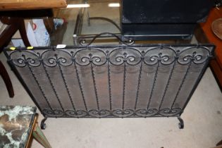 A wrought metal and mesh spark guard