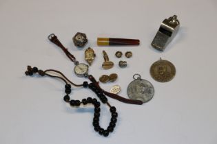 A burr wood box and contents including whistle, me