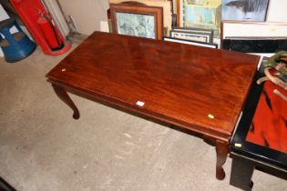 A mahogany oblong coffee table with brass inlay