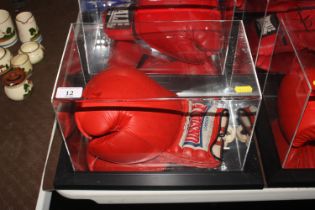 A cased boxing glove signed Frank Bruno