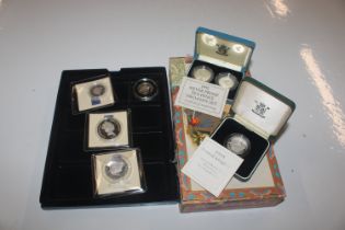 A cigar box and collection of silver proof coins